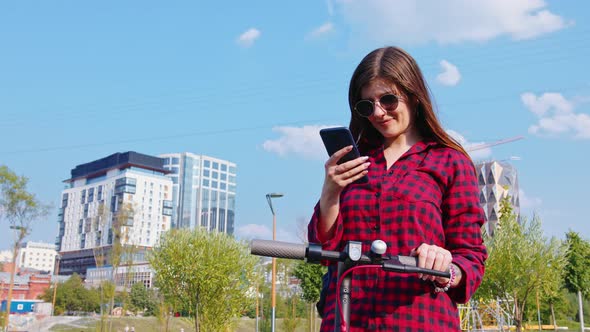 Payment for Escooter By Young Woman at Street alt