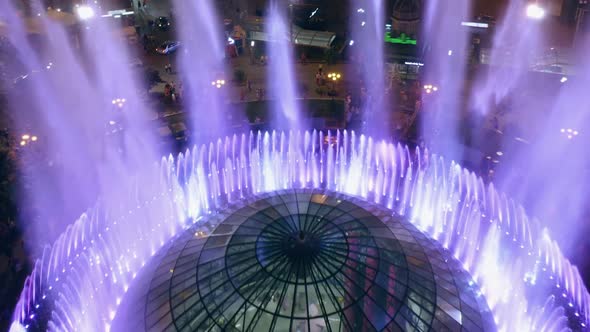 Aerial Top View of Colored Splashing Fountains alt