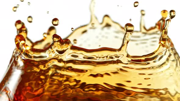 Super Slow Motion Shot of Ice Tea Splash Isolated on White Background at 1000Fps. alt