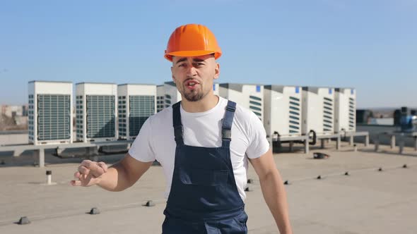 The Engineer is Talking Emotionally and Looking at the Camera alt