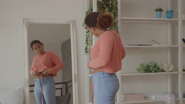 African Woman Upset with Measurement of Waist alt