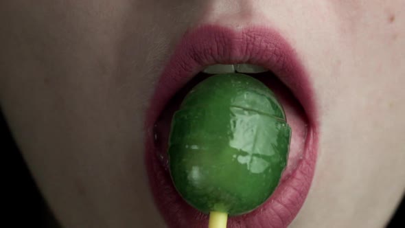 CloseUp Of Girl Licking A Lollipop