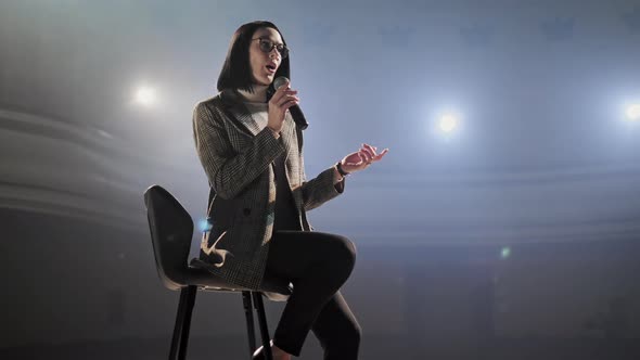 The Female Financial Coach Emotional Gesturing Talks From the Stage with Spectators at Forum. Too alt