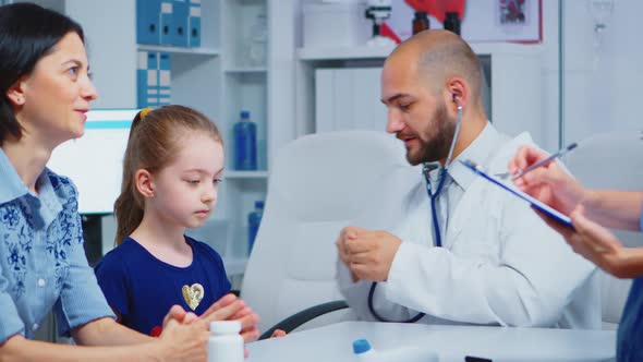 Caring Medical Doctor Consulting with Stethoscope alt