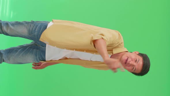 Asian Man Threatening With Finger In The Green Screen Studio alt
