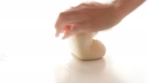 Hand knead dough professional way on white background 4K 2160p 30fps UltraHD footage - Kneading doug alt