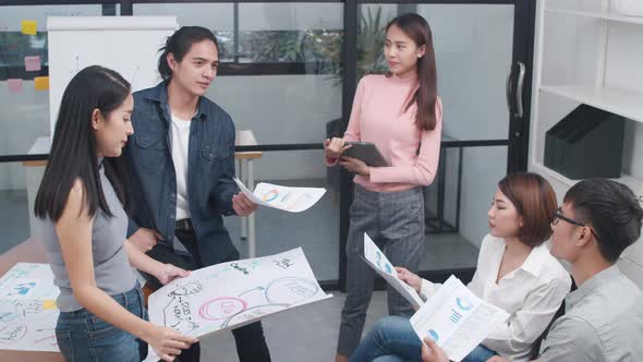 Young Asia business meeting brainstorming ideas  new paperwork project colleagues working together. alt
