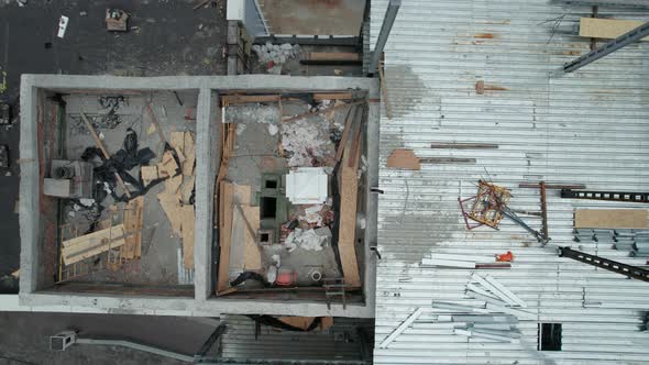 Top Aerial View of a Construction Site on the Roof of a Tall Building alt