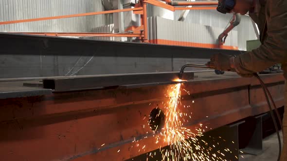 Manual Metal Cutting, Spark Flow and Flame Torch. Protective Masked Welder alt