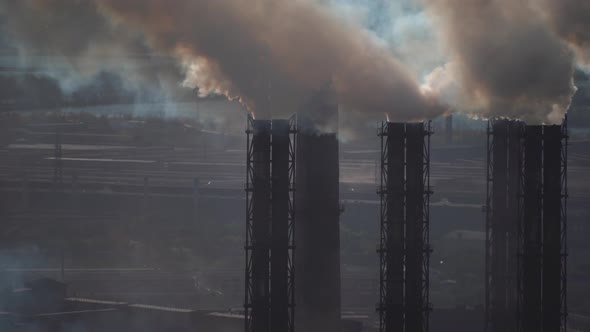 large amount of smoke and soot is emitted from the factory pipes of the metallurgical plant alt