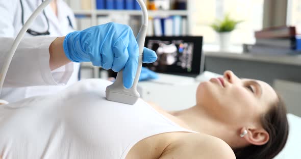 Doctor Conducts Examination of Female Chest Using Ultrasound Scanner alt