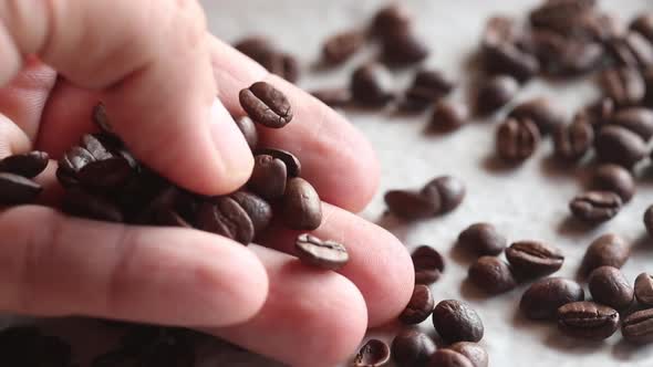 Man holds coffee beans, hd video