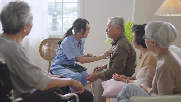 Asian senior people sit in a circle in a nursing home and use stethoscope  listen the heart beating