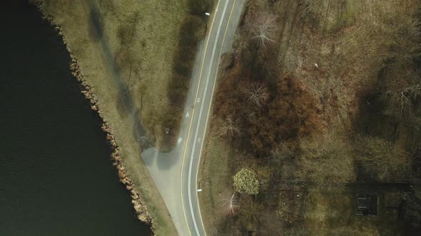 Bicycle path near the city reservoir. Aerial photography. Shot camera down. alt