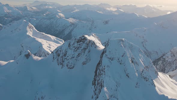 Aerial View From an Airplane of Beautiful Snowy Canadian Mountain Landscape alt