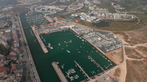 Aerial Drone View of Avenida Dos Descobrimentos Promenade Street with Boats in Marina Port Lagos alt
