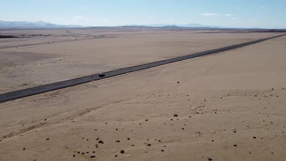 Drone Approaching Car on a Desert Road, Atacama Region, Chile. alt