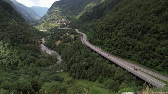 Rise over medieval wall to establish majestic alpine panorama in San Bernardino alt