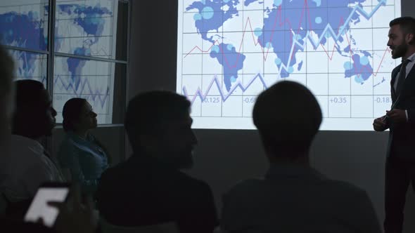 Young Businessman Explaining Statistics alt