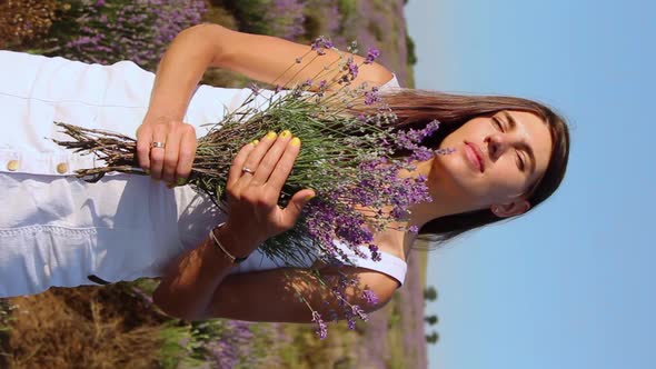 Vertical Video of Woman Smelling Lavender Bouquet