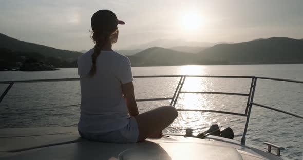 Happy woman enjoying summer vacation on a yacht. alt