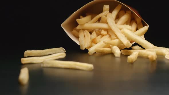 Box with french fries falls on a table