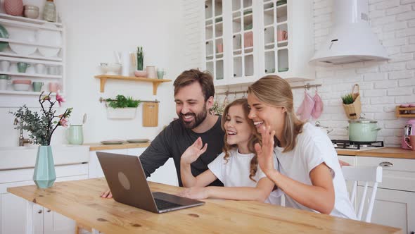 Happy Positive Family Young Parents Couple and Cute Little Daughter Using Laptop Computer for a alt