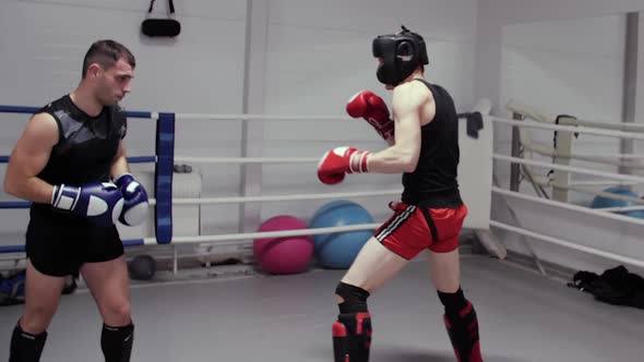 Two Boxers Training High Kick on Ring in Fight Club alt