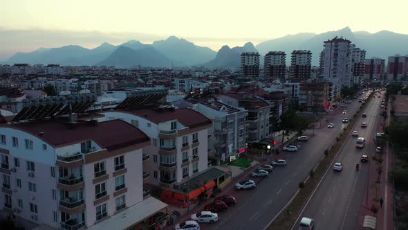Evening Cityscape on the Background of Mountains alt