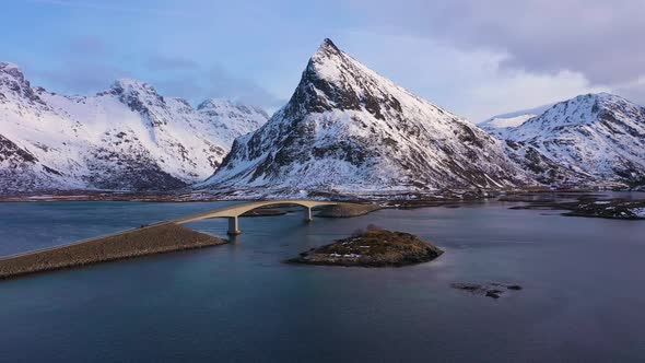 Fredvang Bridge and Volandstind Mountain in Winter. Lofoten, Norway. Aerial View alt