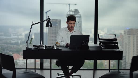 Businessman Reading Good News on Laptop Screen at Workplace. Man Using Laptop alt