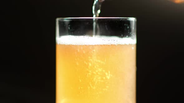 Many Air Bubbles Moving Up in Foam of Alcohol Drink Slow Motion Isolated at Black Studio Background alt
