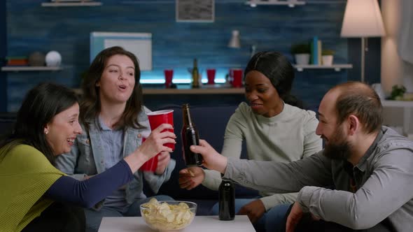 Multicultural Friends Having Fun Time Together Cheering Beer Bottles alt