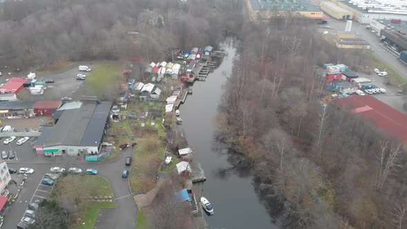Boats and Sheds Next to Canal in Industrial Area Aerial