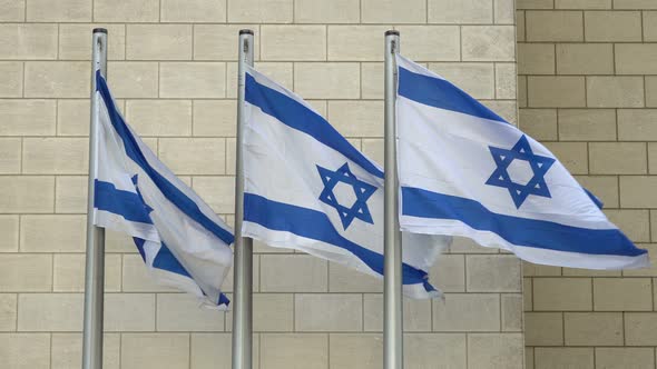 Three Israeli Flags Waving in the Wind Outdoors alt