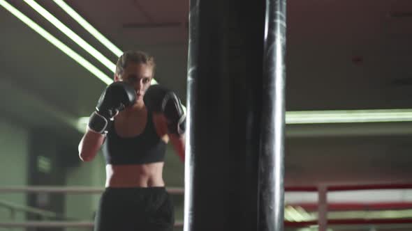 Boxing, Woman Fighter Trains His Punches, Beats a Punching Bag, Training Day in the Boxing Gym alt