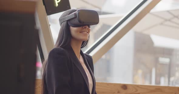 Future VR Education Technology Beautiful Multiethnic Woman Using Virtual Reality Headset to Scroll