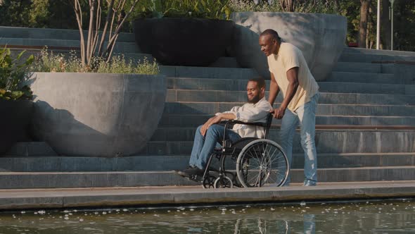 African American Smiling Disabled Bearded Young Man Breathes Fresh Air Enjoying Good Time on Weekend alt