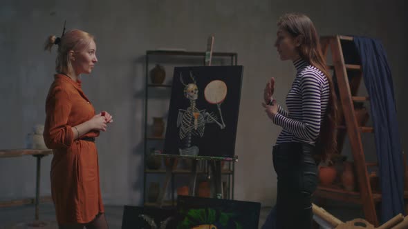 Art Critic Analyzing Paintings of Female Artist alt