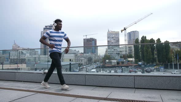 Trendy African American Man Dancing Outdoors alt