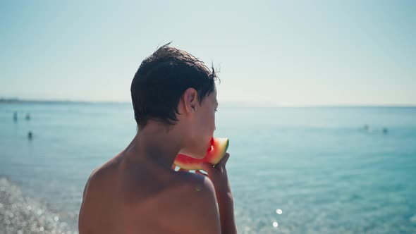 Boy Eating Watermelon on the Beach Summertime alt