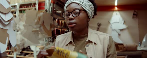 African American Female Shoemaker Speaking on Web Call in Workshop alt