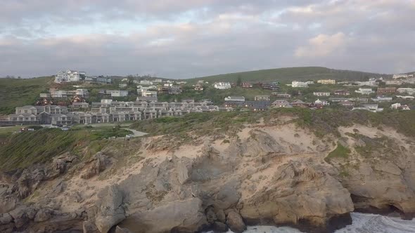 Steep rugged shoreline at Brenton on Sea with seagull attack, aerial alt