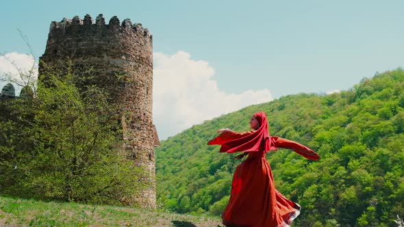 A Girl in a National Georgian Red Dress is Dancing alt