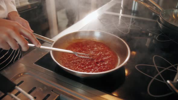 Chef Cooking Tasty Pasta Tomato Sause on Restaurant Kitchen Traditional Italian Food High Kitchen alt