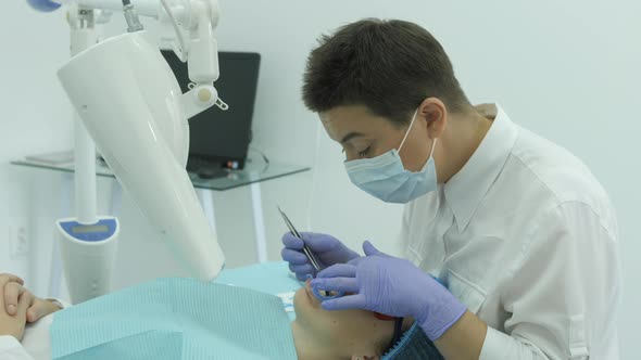 Dentist finishing a whitening treatment alt