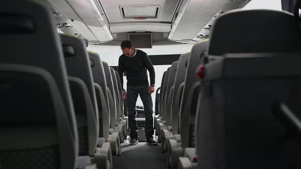 Intercity Bus Coach Driver Preparing His Bus For the Next Trip. alt