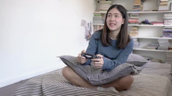 Young woman playing video game alt