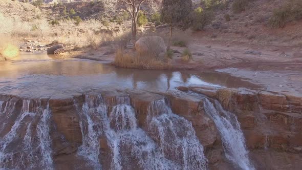Flying backwards over Toquerville Falls in the Utah desert alt