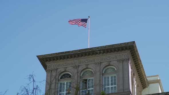 US flag waving on top of a building alt